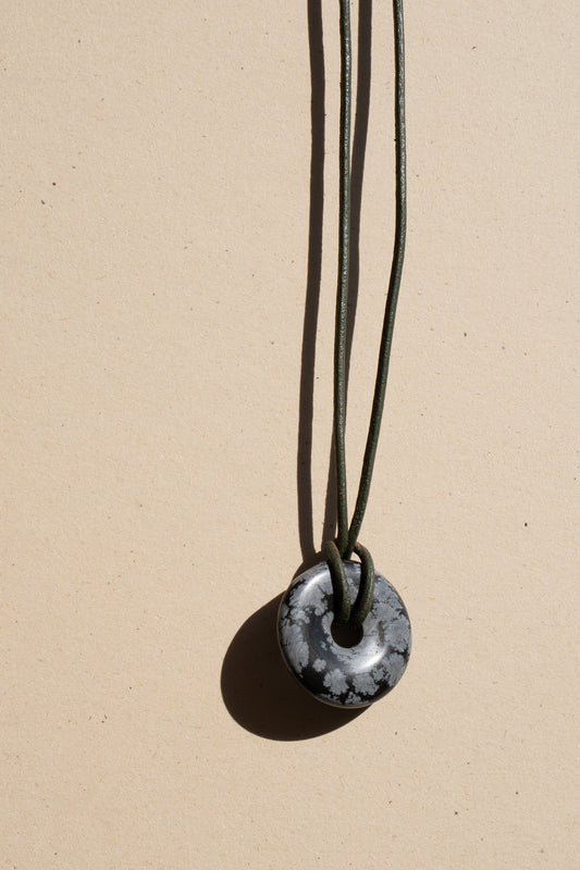 Snowflake Obsidian Donut on black Leather