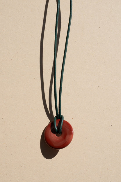 Red Jasper Donut on Green Leather