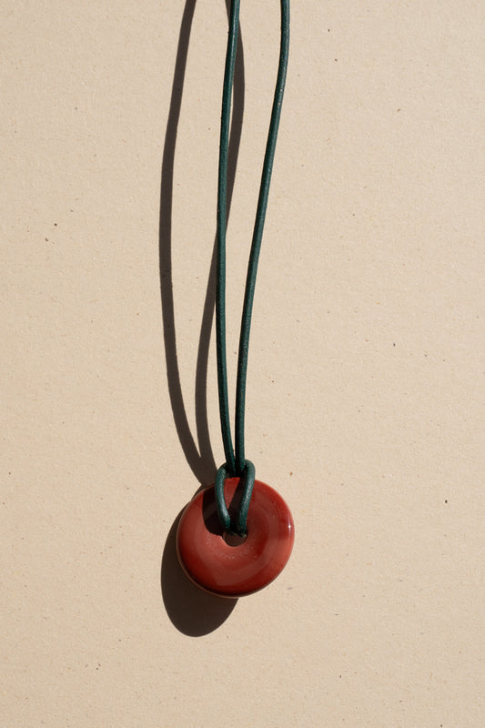 Red Jasper Donut on Green Leather