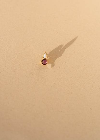 Piercing round ruby and white opal